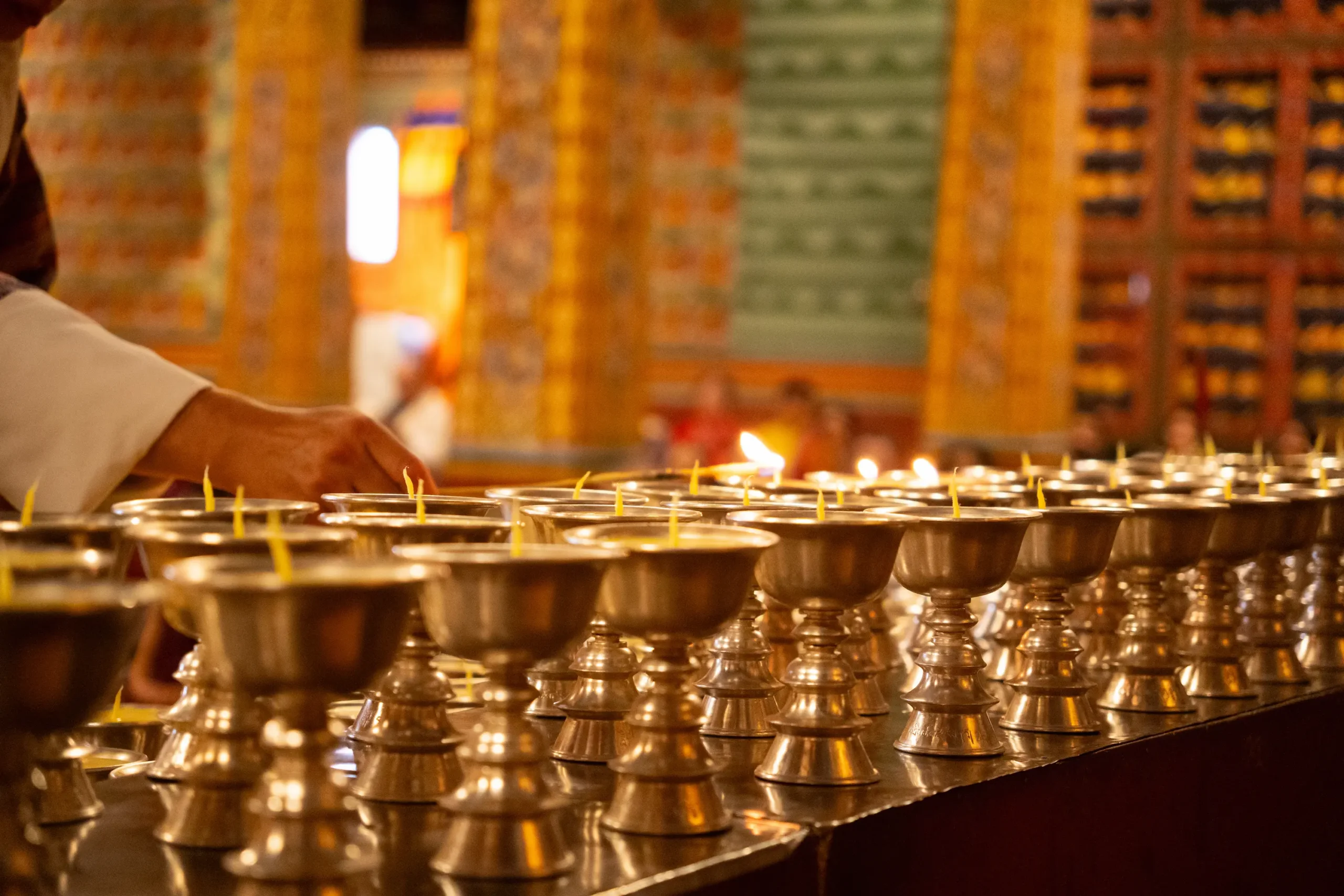 Butter lamps lit in prayer at a Bhutanese temple